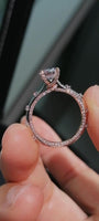 Two-tone band design with pavé-set diamonds; round lab-grown diamond in a four-prong setting, Color D, Clarity VS1.